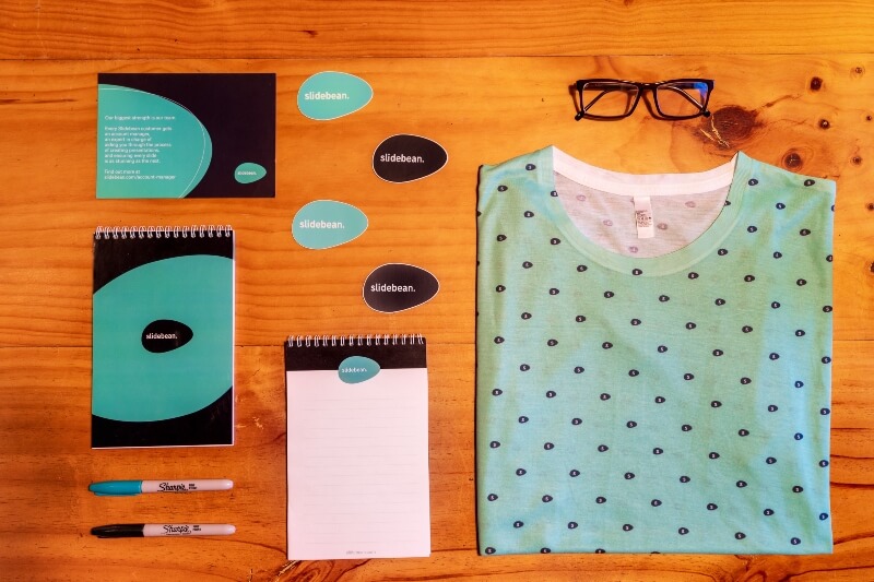 An example of simple yet effective branding on a t-shirt and various office supplies